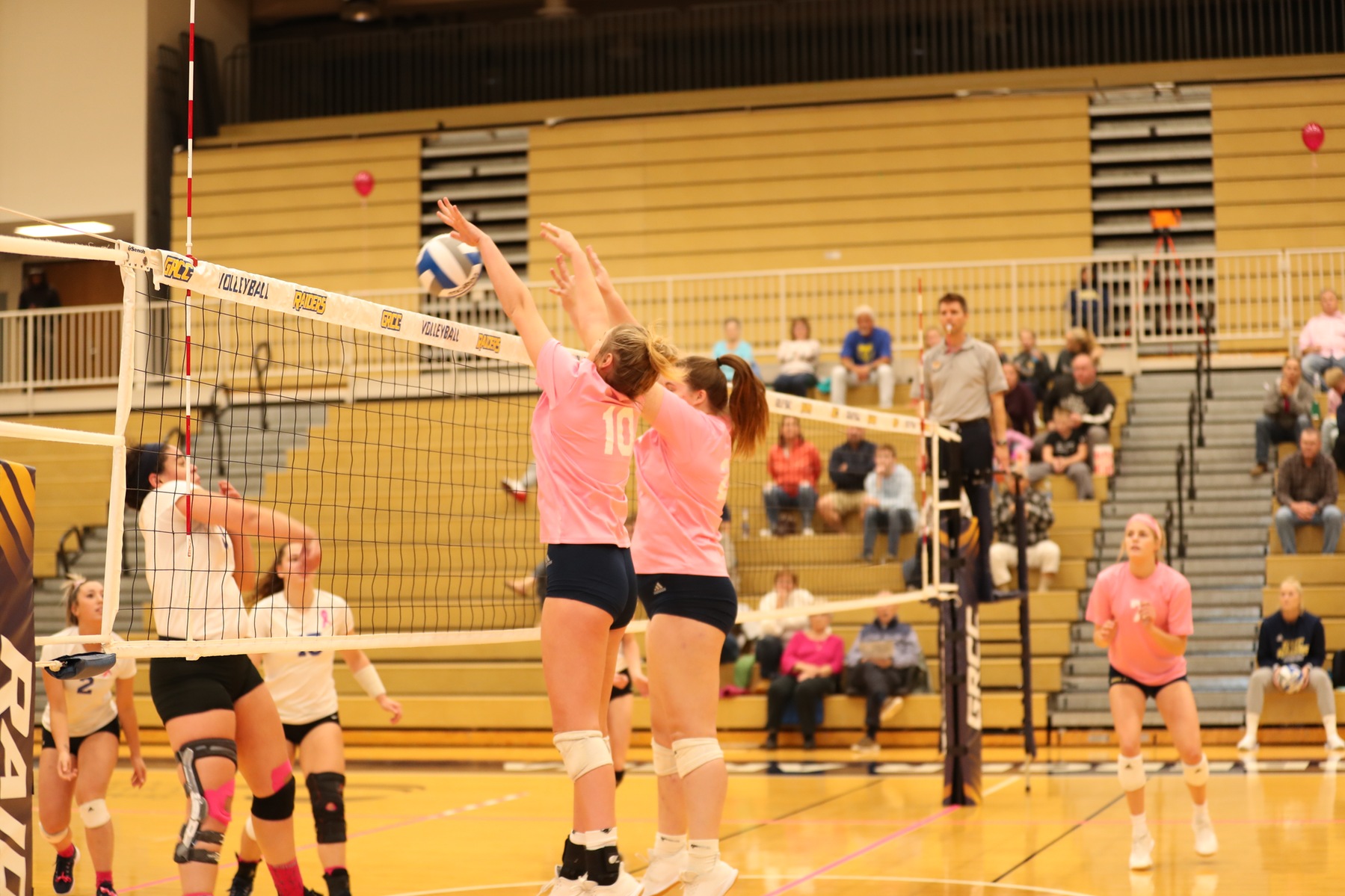 Grand Rapids CC volleyball players go for the block against Kellogg CC